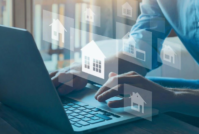 Someone searching on a laptop for residential properties.