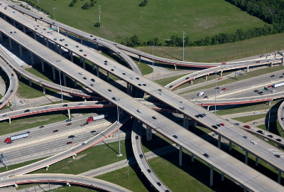 A very busy freeway intersection with traffic going in all directions and four different elevations of freeway levels.